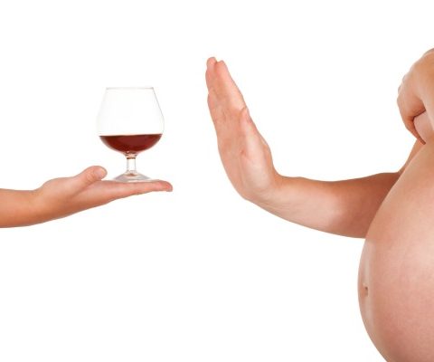 Pregnant woman rejects of taking glass of brandy.